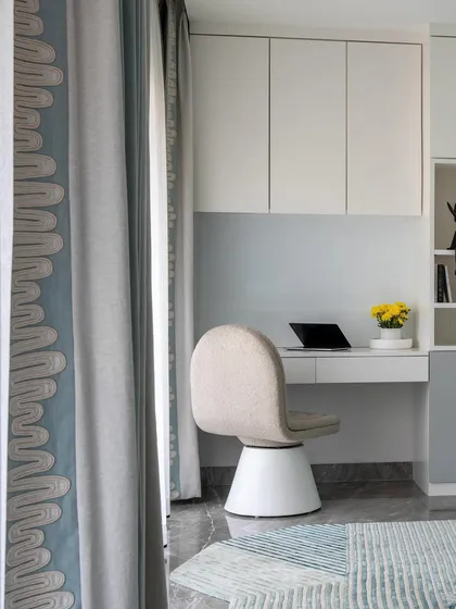 A detail of the study corner in the kids' room. The clean lines of the desk and chair are complemented by the playful arrangement of the storage cabinets, making homework time a little more fun.