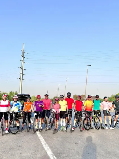 The full group posing on the highway during a summer ride.