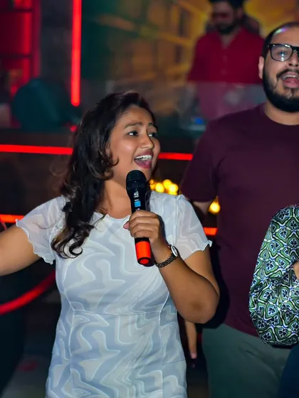 A group performance in full swing. There's nothing like singing a classic anthem with your friends, and I always encourage group numbers to get more people involved.