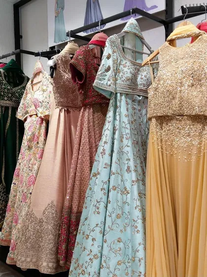 A glimpse of the variety available in my store. Racks filled with designer lehengas and crop-top sets in every color, from pastel blues and pinks to shimmering gold, ready for you to try on.