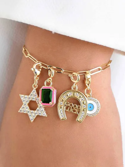 This charm bracelet is all about good luck, featuring a star, a gemstone, a horseshoe, and an evil eye.