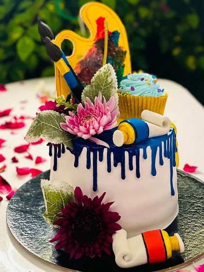 An example of a highly custom, art-themed cake I designed for a creative soul. This eggless cake features edible fondant paint tubes, brushes, and a painter's palette, complete with a surprise cupcake on top. If you have a unique theme in mind, I can bring it to life.