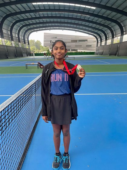 Another proud shot of Sanmitha with her ATF U-14 silver medal, taken on our home courts.