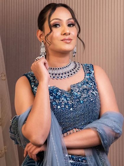 Our client looks stunning in this blue embroidered lehenga, perfectly paired with a rental diamond-style choker and matching earrings for a cohesive and polished look.