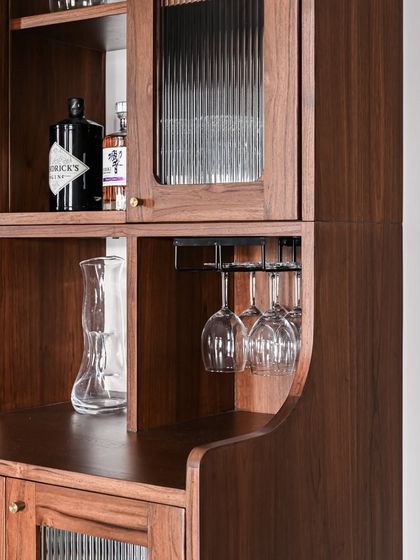 Details of our bar cabinets, including the Sky Bar and the Tarangini Bar Cabinet. These pieces are designed with specific functionalities like bottle storage and glass holders, all within an elegant frame.