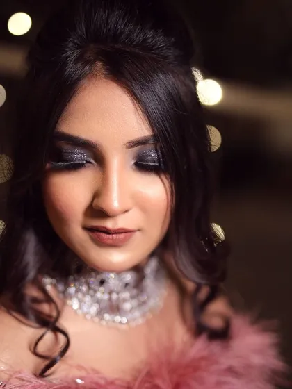 A close-up of Gurusha's dramatic engagement look. The black glitter smokey eye is a bold and glamorous choice, perfect for a cocktail night.