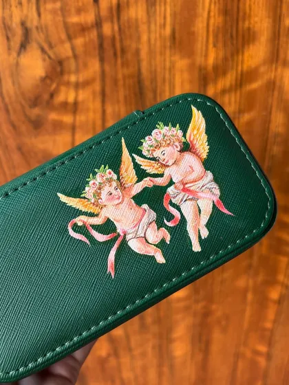 A close-up of the cherub painting, showing the detail in the wings and ribbons.