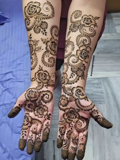 A full-arm floral design with swirling vines and rose patterns. This 'bel' or vine style is very popular for its elegant and flowing look.