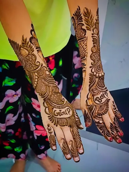 Another shot of the "Girl or Boy?" gender reveal mehandi, showing the playful question integrated into an elegant Arabic-style design.
