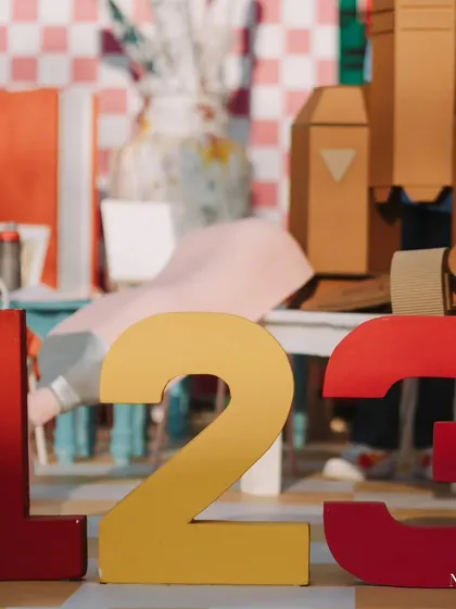 Simple yet effective decor elements like these large numbers add a pop of color and a clear celebratory message to the party space.
