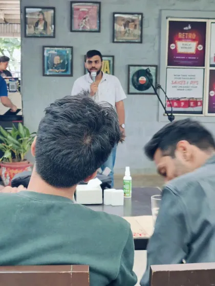 Another view of our stand-up comedy event, showing the comedian engaging with the audience in our open-air setting during a beautiful afternoon.