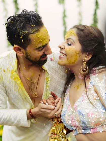 A duplicate of a sweet, romantic moment amidst the Haldi fun. Her makeup still looks fresh and glowing.