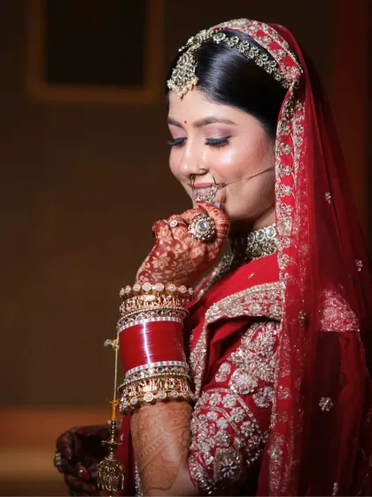 A candid, happy moment. The bride's makeup is flawless, with a focus on a radiant base and eyes that sparkle, making her look and feel her best.