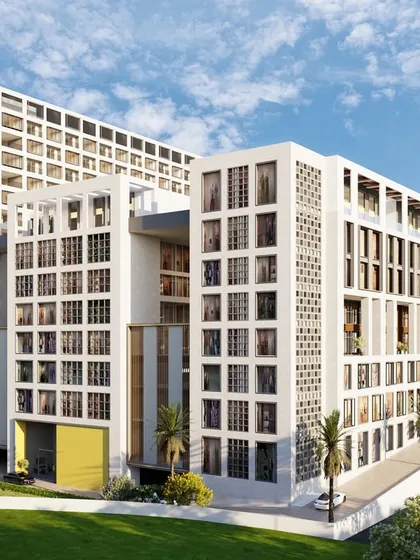 This view highlights the building's unique form and fenestration. The design creates a landmark that is not just visually striking but also functional, housing a mix of uses that contribute to a vibrant urban environment.