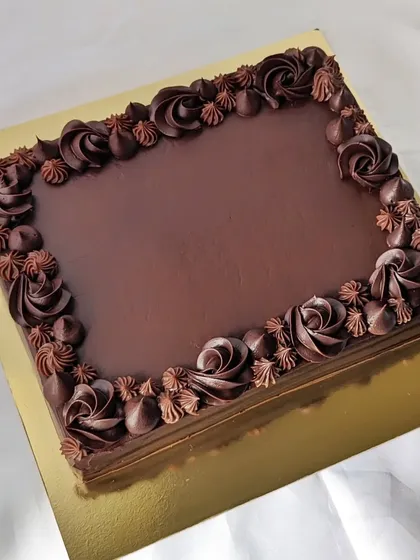 A rich chocolate ganache sheet cake is a crowd-pleaser for any office occasion. It provides a large surface for custom messages, like the one I made to celebrate a YouTube milestone.