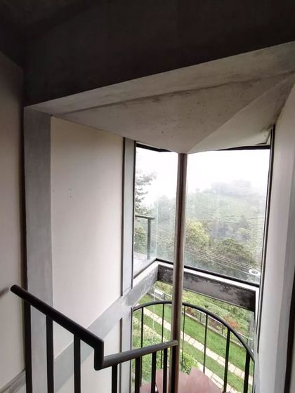An innovative detail at a VAY villa in Coonoor, where the central support for the spiral staircase also functions as a rainwater gutter. Water from the roof is channeled through this pipe into a storage tank below, integrating water harvesting directly into the architectural form.