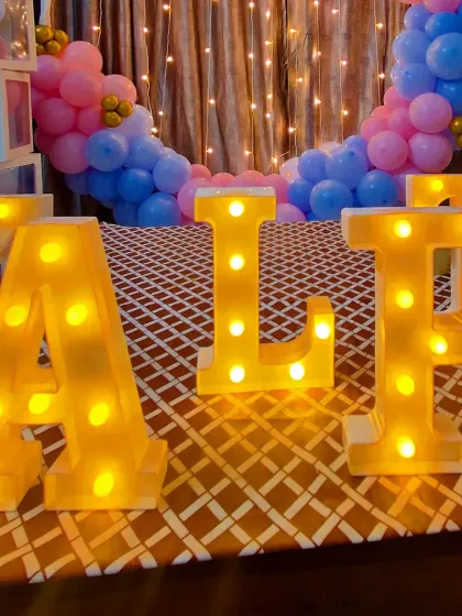 A detailed shot of the large, bright marquee letters used to spell out the baby's name.