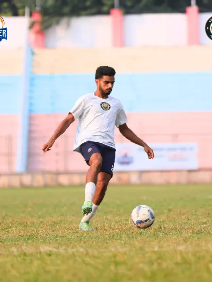 A player prepares to make a pass, demonstrating vision and awareness on the field.