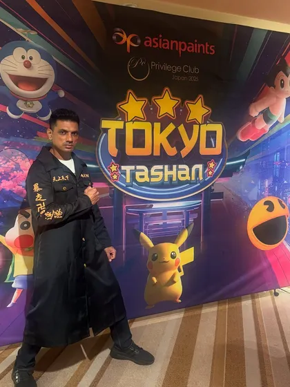 A powerful pose in front of the event branding in Tokyo. These large-scale international events require precision, professionalism, and a whole lot of energy.