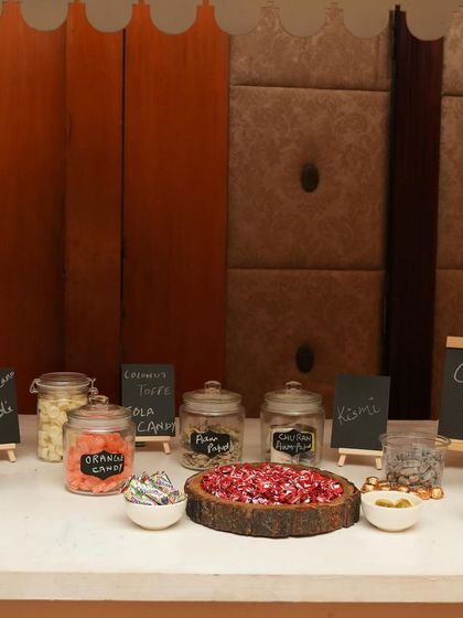 A close-up of the nostalgic candy selection on the 'Bachpan Ki Yaadein' cart, featuring old-school favorites in glass jars.
