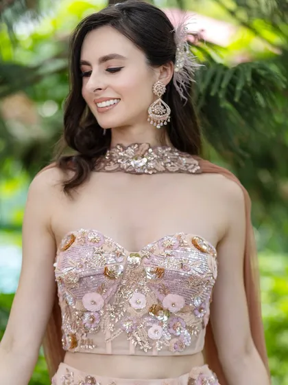 A smiling portrait of our model in a beautiful pastel outfit. The nude makeup look enhances her natural features perfectly.