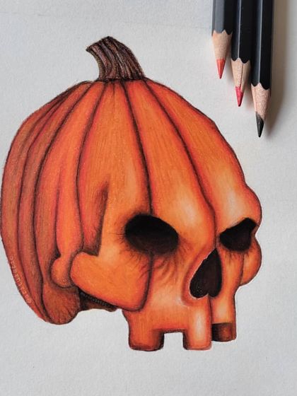 The pumpkin skull drawing shown with the orange, red, and black pencils used to create its spooky glow.