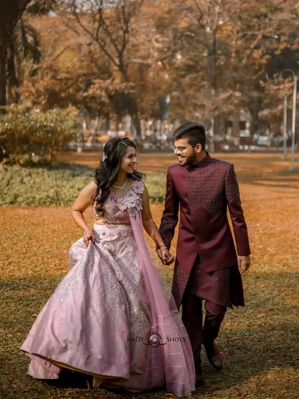 A walk in the park during their engagement shoot. The autumn colors and their coordinated outfits create a beautiful, romantic scene.
