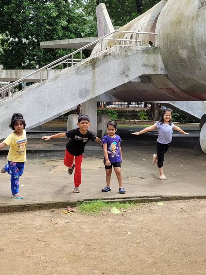 Practicing airplane pose in the park. Outdoor yoga allows kids to spread their wings and connect with the world around them in a whole new way.