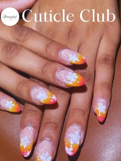 A bright and cheerful design with a pink and orange ombre tip, decorated with hand-painted white flowers.