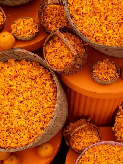 Baskets filled with fresh marigold petals. This simple yet beautiful detail adds to the traditional and sensory experience of a haldi or mehendi ceremony.