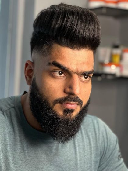 A front view of this bold style. The height on top and the sharp fade create a very dramatic look.