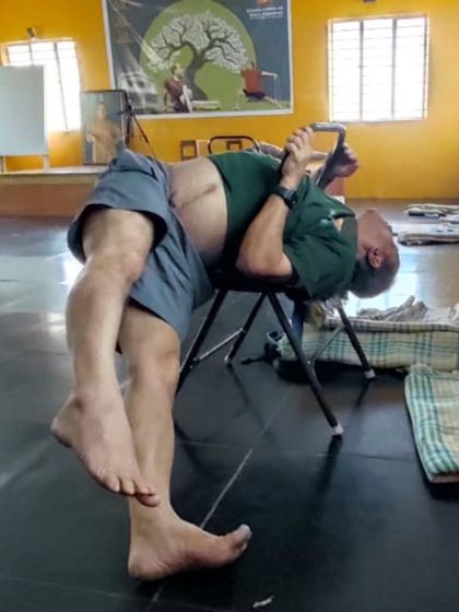 A twisting pose on a chair.