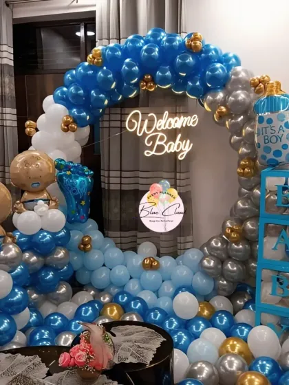 A grand 'Welcome Baby' boy decoration with a full balloon ring, neon sign, and 'BABY' blocks.