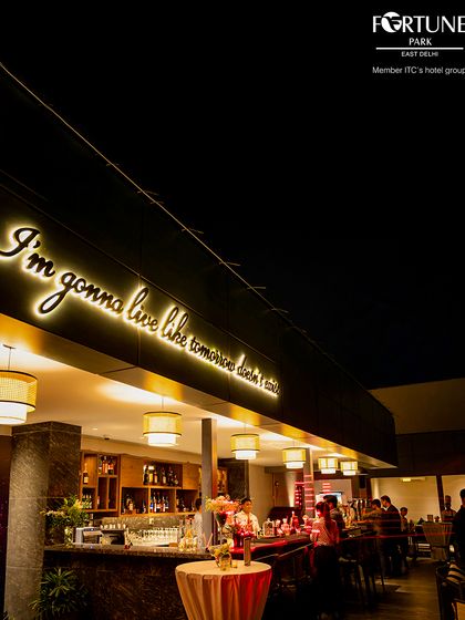 The full view of the Nakshatra bar at night, lit up and buzzing with energy. It's the heart of our rooftop experience.