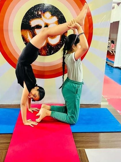 This partner pose requires balance and trust from both children. It's a beautiful way for them to learn how to work together and build strength.