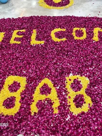 A close-up of the "WELCOME BABY" message made from yellow and red flower petals, a beautiful and traditional way to celebrate.