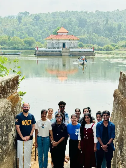 Our group at the serene Kere Basadi, the beautiful floating Jain temple in Varanga, a unique stop on our coastal tour.