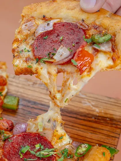 That perfect cheese pull. We know how to capture the classic, irresistible moments that make customers crave your food. This shot of a pepperoni pizza is a prime example of our ability to create universally appealing food photography.