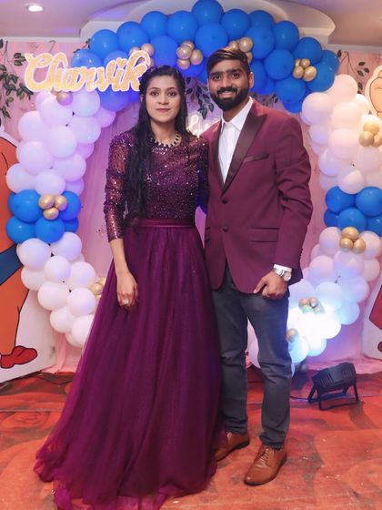 A happy couple celebrating a birthday together. The purple sequined gown and coordinating blazer make for a stylish pair.