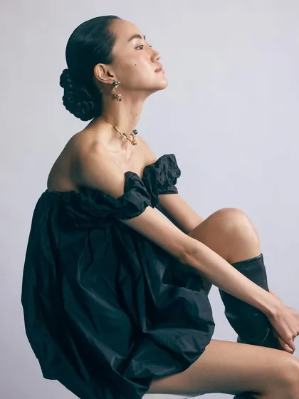 A different look from the Voyce Jewellery shoot, featuring a voluminous black dress. The pose is elegant and highlights the necklace and earrings.