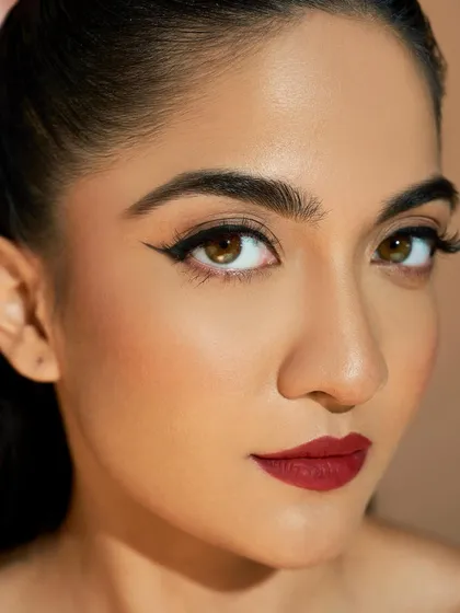 For the bride who loves a bold statement, this look is all about precision. A sharp, graphic winged liner paired with a classic matte red lip creates an unforgettable and glamorous style, perfect for a cocktail or reception event.