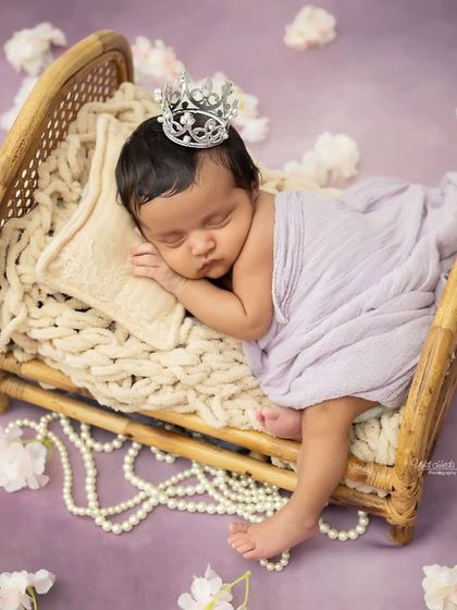 This little princess is sleeping so soundly on her miniature bed, adorned with a tiny silver crown.