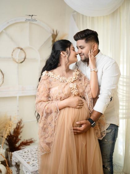 An intimate close-up of the couple, their faces close, sharing a quiet moment. The soft lighting and gentle expressions make this a truly romantic shot.
