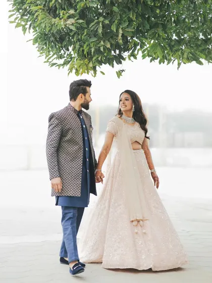 A sweet and simple portrait of the engaged couple walking hand-in-hand, enjoying a quiet moment together.