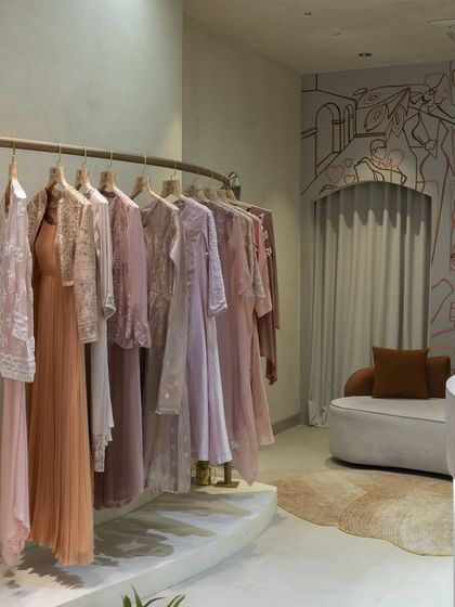 Another view of the boutique mural, showing how it creates a sophisticated and artistic backdrop for the clothing racks.