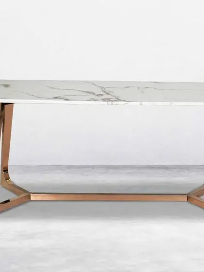 Another dining table option with a white marble top and a more streamlined rose gold metal base.