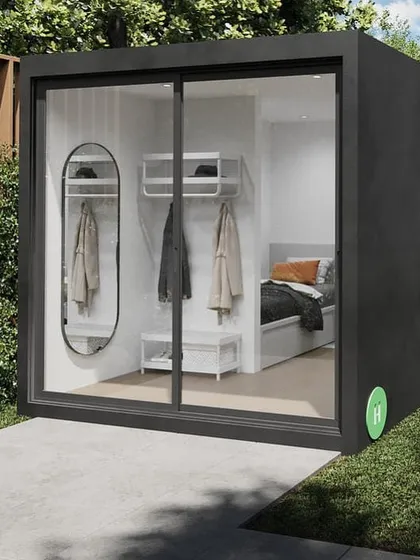 Our signature backyard pod is a versatile solution for adding extra space. This model, shown here with a sleek black frame and sliding glass wall, can be installed in just two months and serves perfectly as a home office, gym, or private studio.