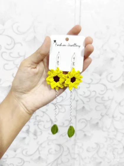 My popular dangling sunflower earrings. These feature a bright yellow sunflower top with a delicate chain leading to a small crocheted leaf.
