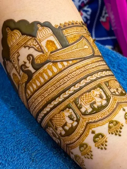 A detailed shot of a doli on an elephant, a classic and beloved motif for bridal mehandi.