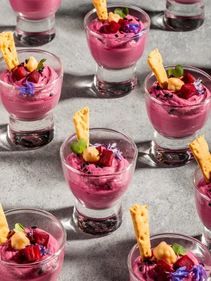 Velvety, vibrant, and vegan. Our Burgundy Beetroot Hummus is a star on any spread, served here in individual shot glasses with a crispy lavash stick.